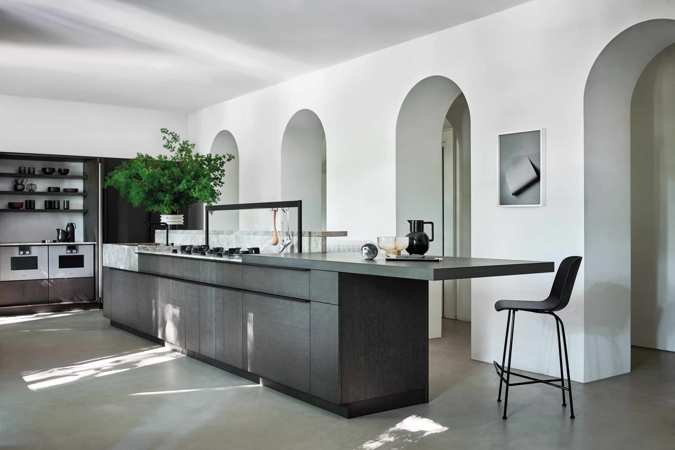 Spacious Intarsio kitchen with wood-patterned cabinets, integrated oven, and large island